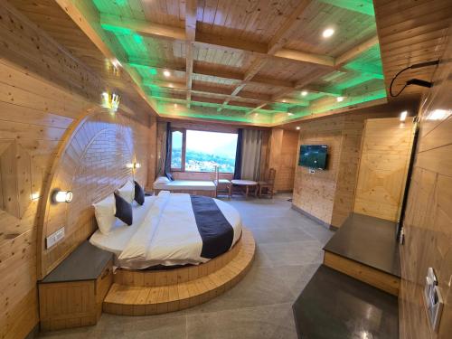a bedroom with a bed in a room with wooden walls at The Park Green Resorts in Manāli