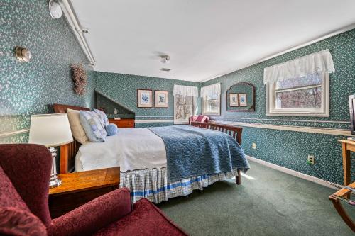 a bedroom with a bed and a chair at Inn at Jackson in Jackson
