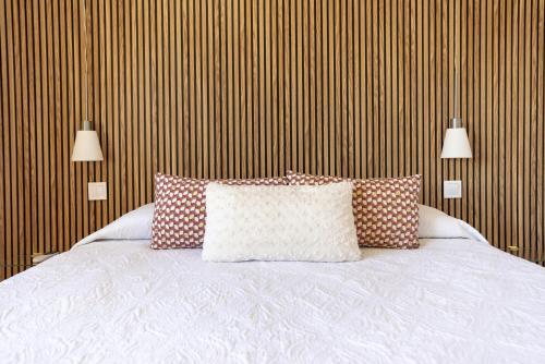 a bedroom with a bed with pillows on it at ApartRincón Candelaria in Rincón de la Victoria