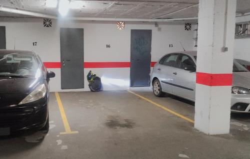 a parking garage with two cars parked in it at ApartRincón Candelaria in Rincón de la Victoria