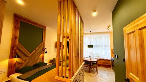 a bedroom with a bed and a table in a room at City Vibe Studio in Poznań