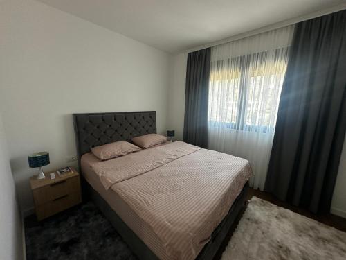 a bedroom with a large bed and a window at Dali Apartment in Bar