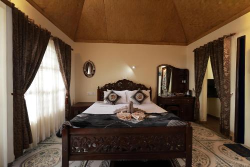 a bedroom with a bed with a large mirror at Kerala cottage in Varkala