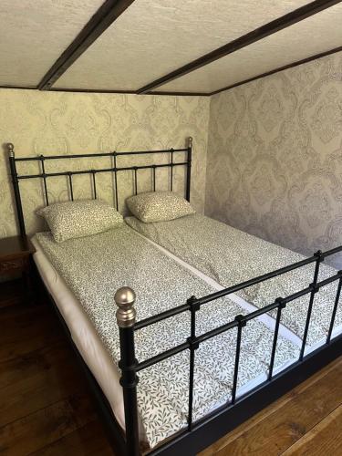 a metal bed with two pillows on top of it at Paradise on the Vrbas River in Jajce