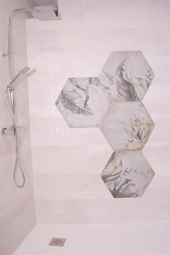 a bathroom with a shower with two towels at Casa Rural La Canaleja in Berrocalejo
