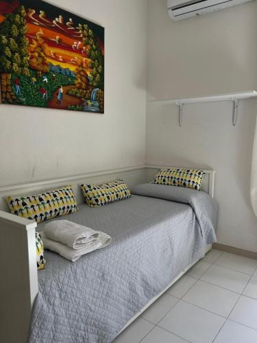 a bedroom with a bed and a painting on the wall at La mia casetta in Taormina