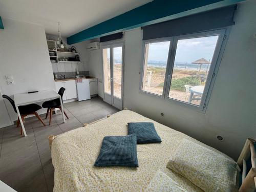 a bedroom with a bed and a view of the ocean at Ô Bord de Mer ! in Hyères