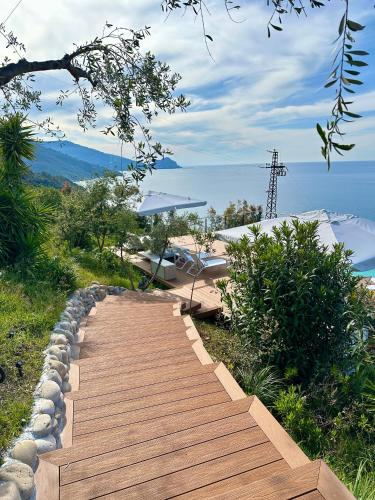 a wooden stairway leading up a hill to the water at Villa Torre Conca Cefalu Coast in Finale