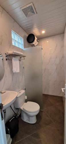 a bathroom with a toilet and a sink at Umah D'Kancagan in Ungasan
