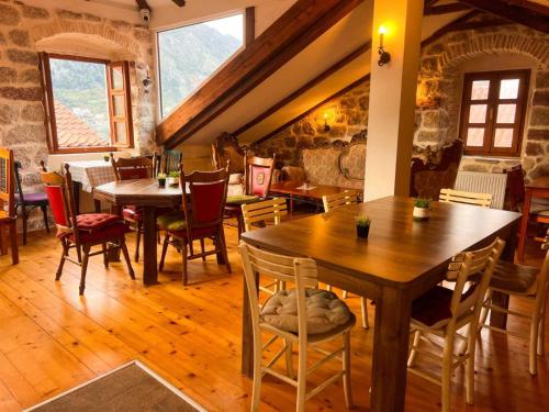 a dining room with wooden tables and chairs at Old Town Youth Hostel in Kotor