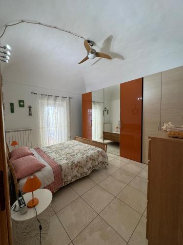 a bedroom with a bed and a ceiling fan at Dimora Marisa in Termoli
