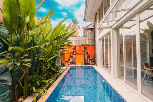 a swimming pool in the middle of a house with plants at Modern Villa near Seminyak & Canggu, Large Pool in Kerobokan