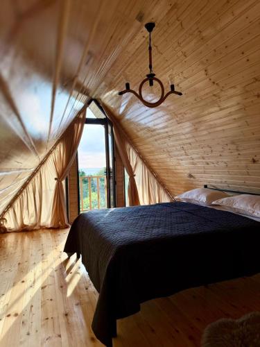 a bedroom with a large bed in a tent at Greenside Buknari in K'veda Ulianovka
