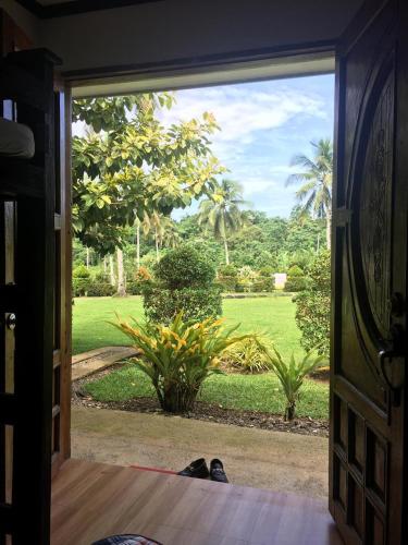an open door with a view of a yard at Libhu Hill Resort and Sports Complex in Maasin