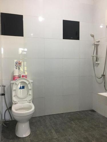 a bathroom with a toilet and a sink at Libhu Hill Resort and Sports Complex in Maasin