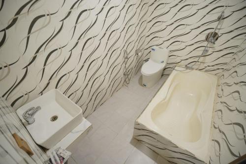 a bathroom with a sink and a toilet at Chandrama Hotel and Restaurant in Sauraha