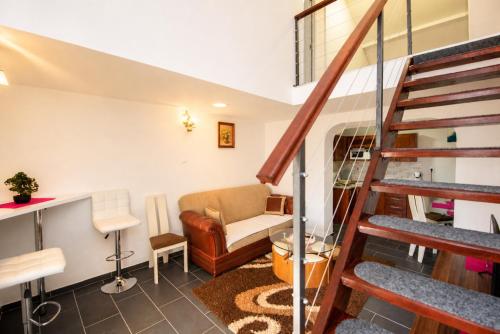 a living room with a staircase and a couch at Apartments Duplex Oliva in Trebinje
