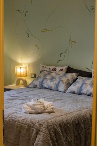 a bedroom with a bed with towels on it at Ai tre camini in Adro