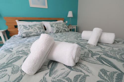 a bed with two white towels on it at Corfu Green Escape in Achílleion
