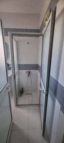 a bathroom with a shower with a glass door at Maison à louer in Chebba