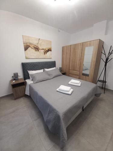 a bedroom with a large bed with two towels on it at Velania House 2 in Filótion