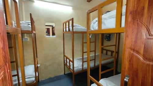 a room with four bunk beds in a room at singh homestay in Varanasi