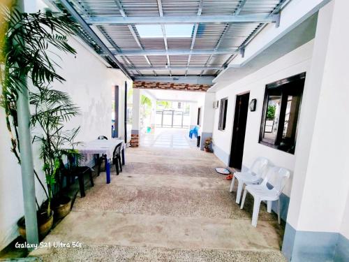 a hallway with tables and chairs in a building at CM Star Suites - Guesthouse in Vigan
