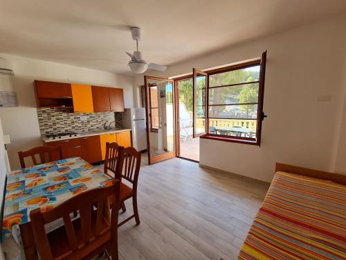a kitchen and dining room with a table and chairs at Residence Olimpia in Peschici