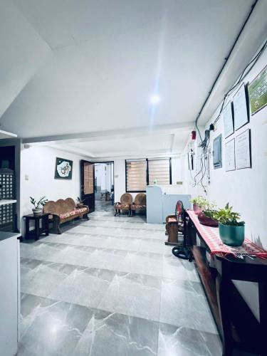 a living room with a large tile floor at CM Star Suites - Guesthouse in Vigan