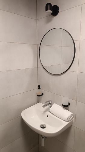 a bathroom with a white sink and a mirror at Dvorek110 in Roudnice nad Labem