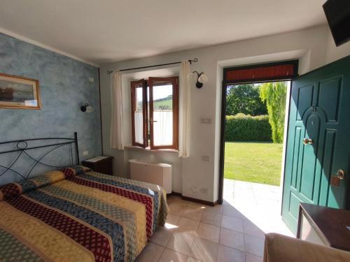 a bedroom with a bed and a door to a yard at B&B La Tenuta del Conte in Fermo