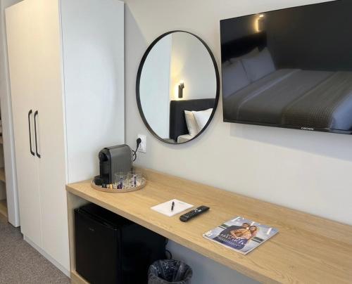 a mirror sitting on a counter in a room at HOTEL BRIZ - Free Parking in Burgas