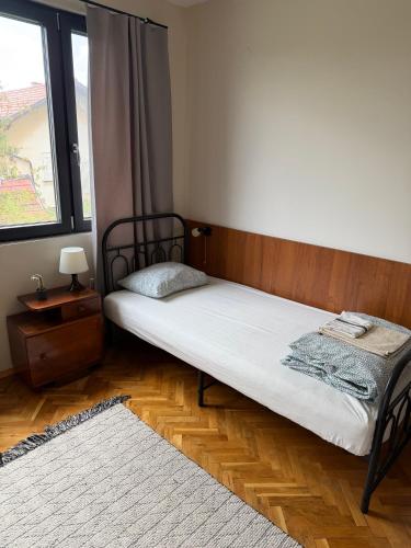 a small bed in a room with a window at Bankya Guest House - Sofia in Bankya