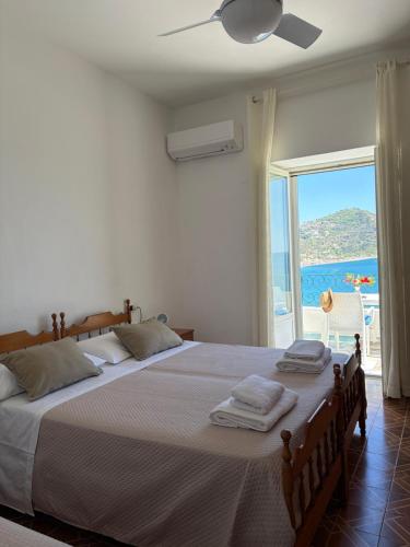 a bedroom with two beds with a view of the ocean at Villa Egidio Terrazza in Sant'Angelo D'Ischia