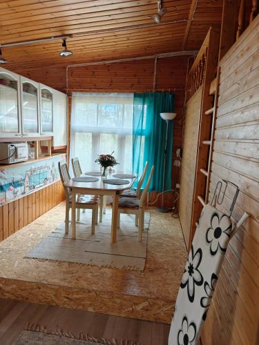 a dining room with a table and chairs at Ranta mökki in Kouvola