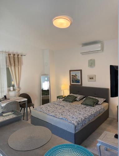 a bedroom with a bed and a living room at Rab Studio first floor 32m2 in Kampor