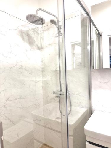 a bathroom with a shower with a glass door at Sand and stone oasis in Ohrid