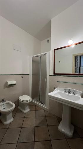 a bathroom with a toilet and a sink and a shower at Chicca's Apartments Gallipoli in Gallipoli