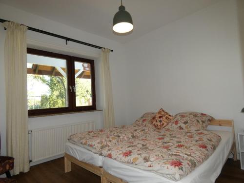 a bed in a room with a window at fewo1846 - Romanze - idyllische Wohnung mit Garten im Grünen in Gelting