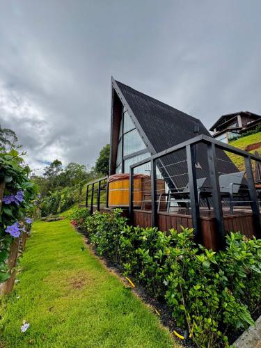 a house with a garden in front of it at Cabana Veneza in Santa Teresa