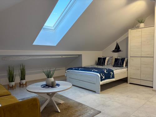 a bedroom with a bed and a skylight at Poddasze Na Mazurach in Pisz