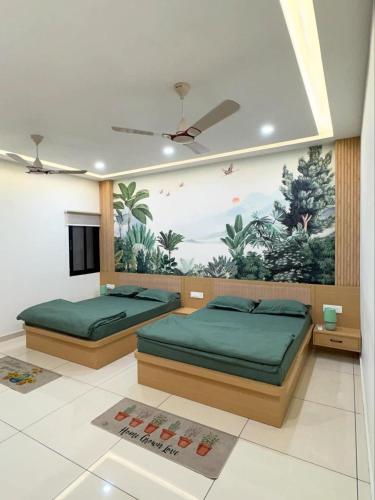 two beds in a bedroom with a painting on the wall at Luxury private pool villa for families & groups in Ujjain