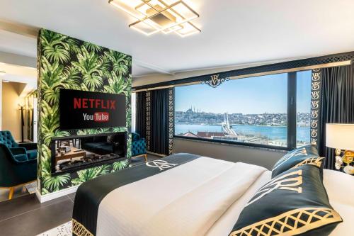 a bedroom with a bed and a large window at Bellavia Deluxe Apart in Istanbul