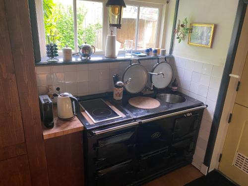 a kitchen with a sink and a stove with two mirrors at Genesis Voorschoten in Voorschoten