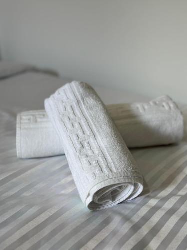 a close up of a white object on a bed at Bloom House Përmet in Përmet