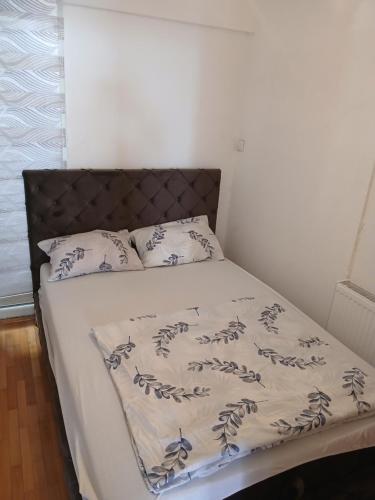 a bedroom with a bed with a bedspread and pillows at Apartman Danica in Foča
