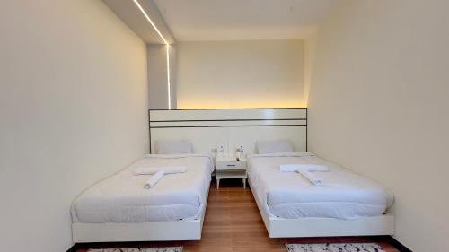 a small room with two beds in it at Mamush Hotel in Ārba Minchʼ