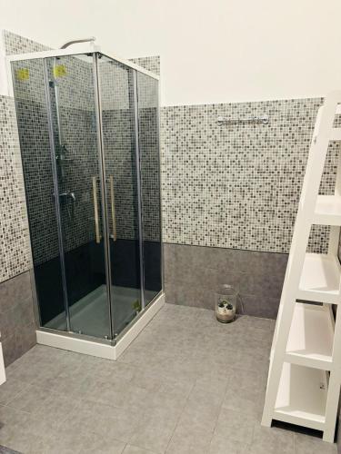 a shower with a glass door in a bathroom at Domus Alberta in Lecce