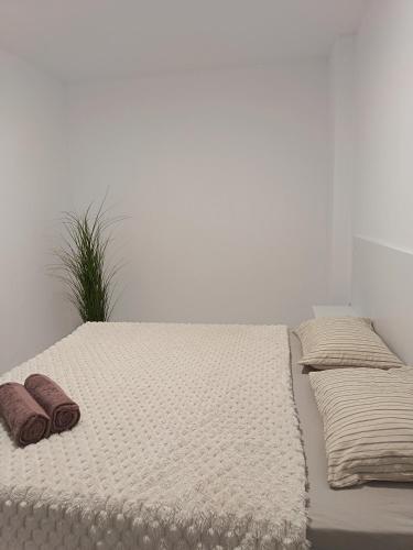 a white bed with two pillows on top of it at Boutique apartment yellow 1 in Plovdiv