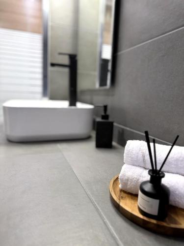 a bathroom with a sink and towels on a table at The Lithos Loft Kyma in Ayía Marína